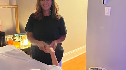 Therapist at H & A Spa in Cranston, Rhode Island, US providing a calming hand massage.