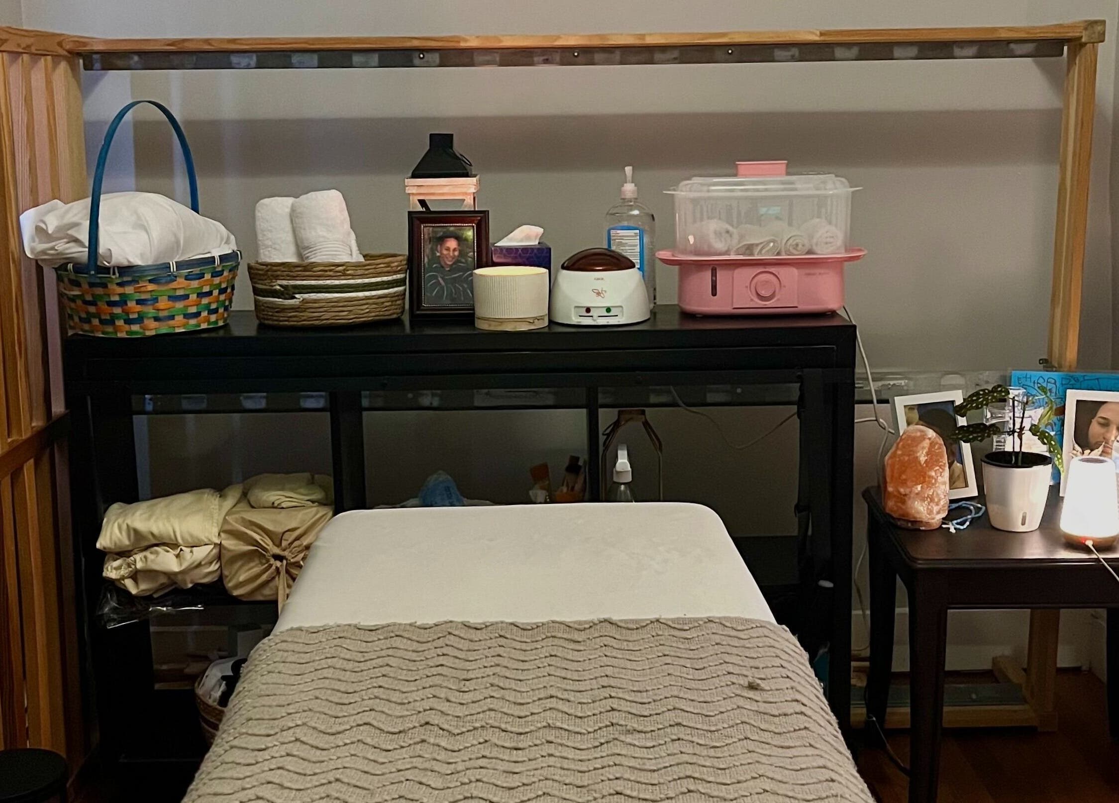Massage room setup at H & A Spa in Cranston, Rhode Island, US featuring a cozy treatment bed and calming ambiance.
