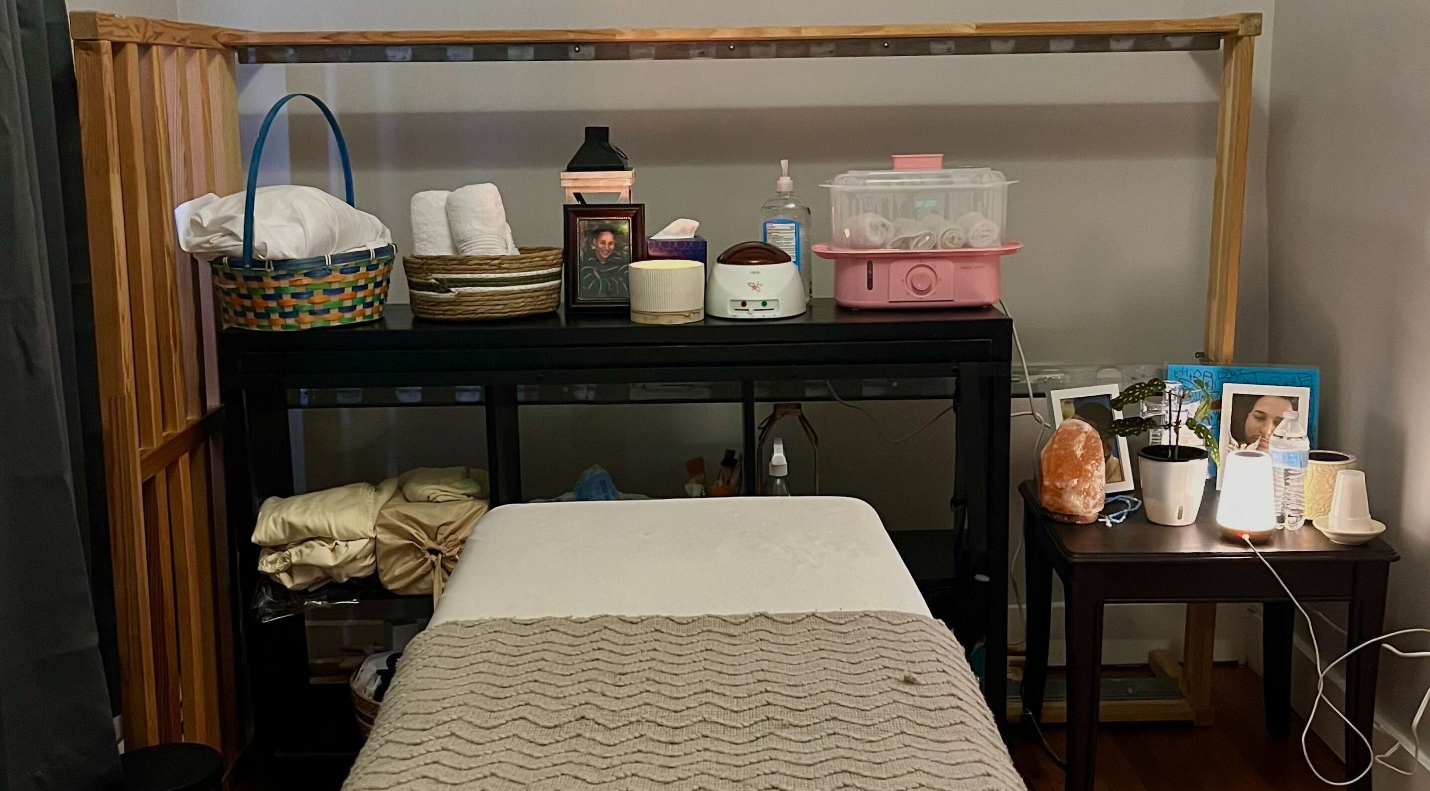 Massage room setup at H & A Spa in Cranston, Rhode Island, US featuring a cozy treatment bed and calming ambiance.