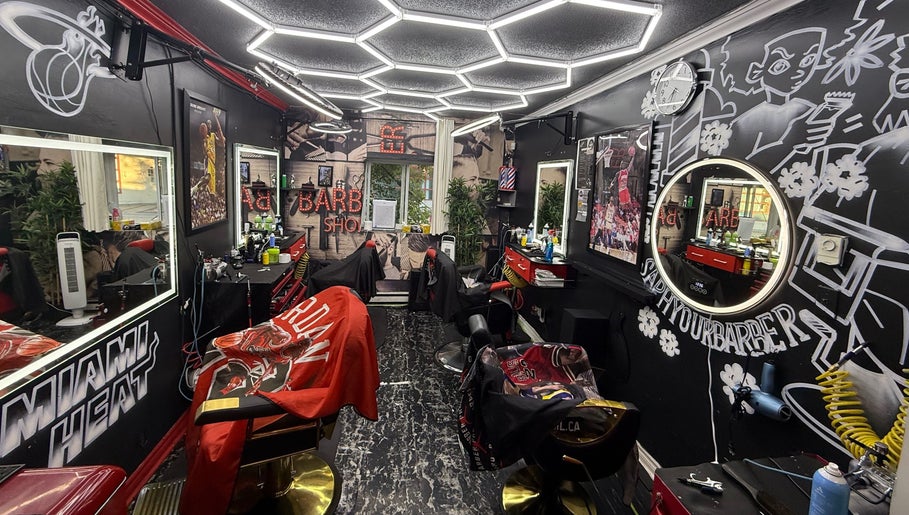 Stylish interior of Klassik Barbershop in Ottawa, Ontario, CA, showcasing vibrant decor and barber chairs.