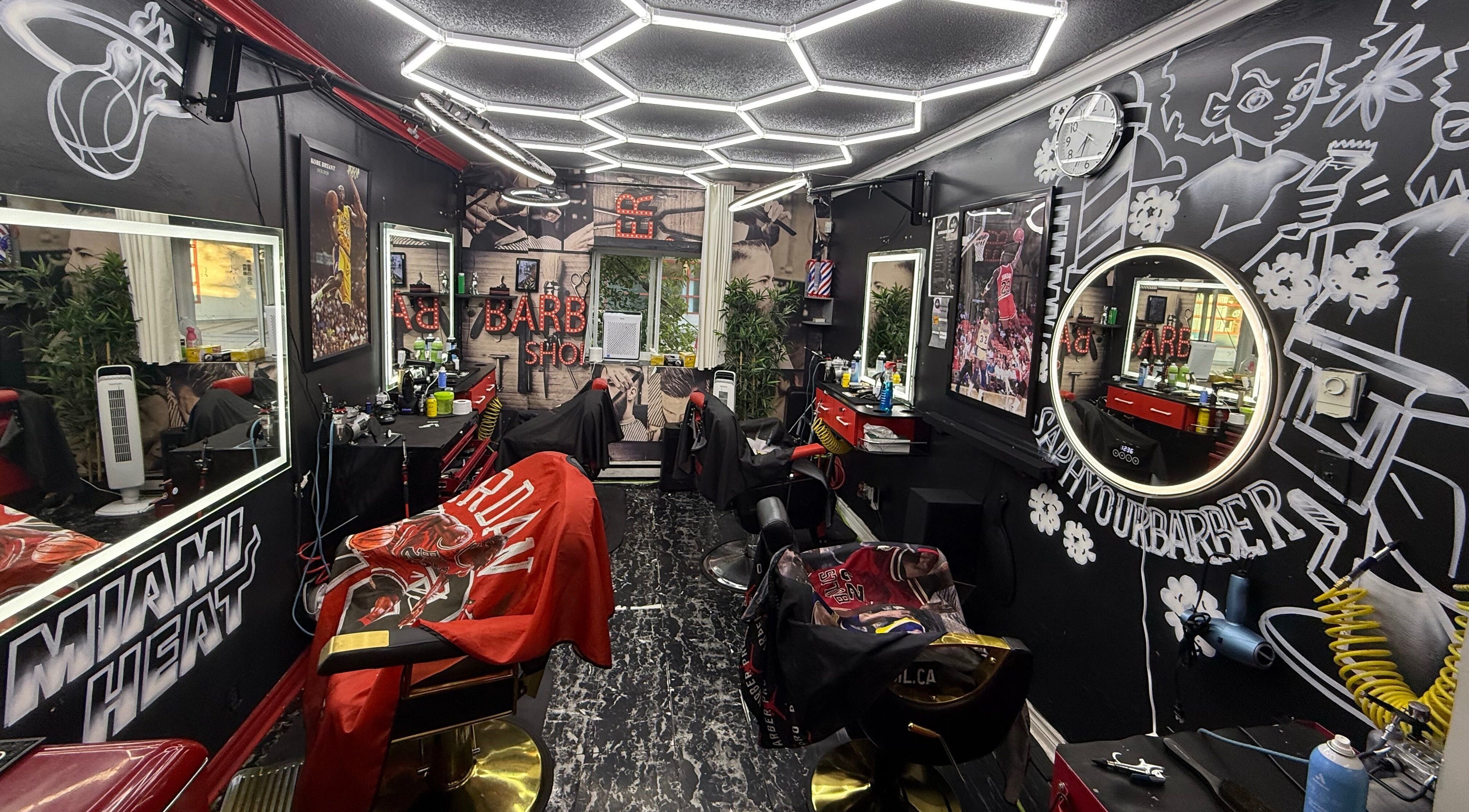 Stylish interior of Klassik Barbershop in Ottawa, Ontario, CA, showcasing vibrant decor and barber chairs.