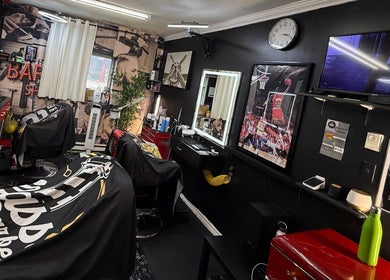 Interior of Klassik Barbershop in Ottawa, Ontario, CA with sleek design, barber chairs, and sports decor.