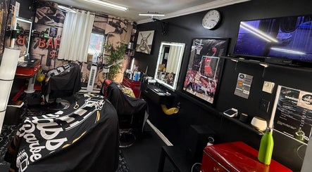 Interior of Klassik Barbershop in Ottawa, Ontario, CA with sleek design, barber chairs, and sports decor.