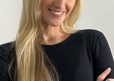 Smiling woman with long hair at Emily Cowie Cosmetics, Wrentham, England, GB.