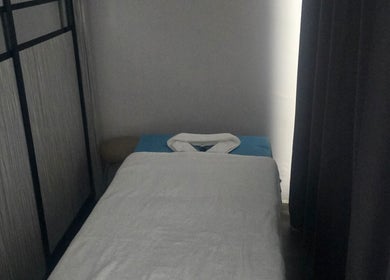 Tranquil massage room at Equality Beauty Spa, Singapore, SG, featuring a cozy treatment bed.