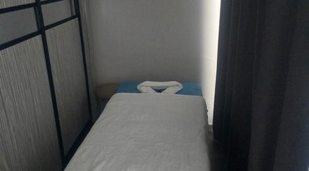 Tranquil massage room at Equality Beauty Spa, Singapore, SG, featuring a cozy treatment bed.