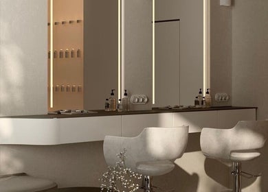 Luxurious salon workstation at Minique Beauty, Richmond, Victoria, AU with sleek chairs and modern lighting.