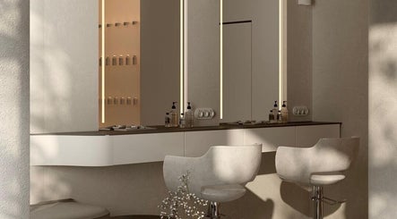 Luxurious salon workstation at Minique Beauty, Richmond, Victoria, AU with sleek chairs and modern lighting.