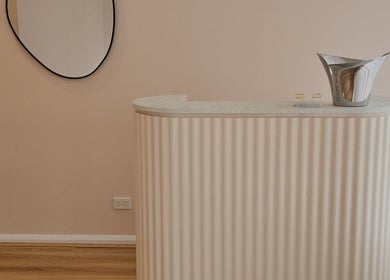 Elegant reception at Miss Volume, Rose Bay, New South Wales, AU with stylish decor and curved counter.