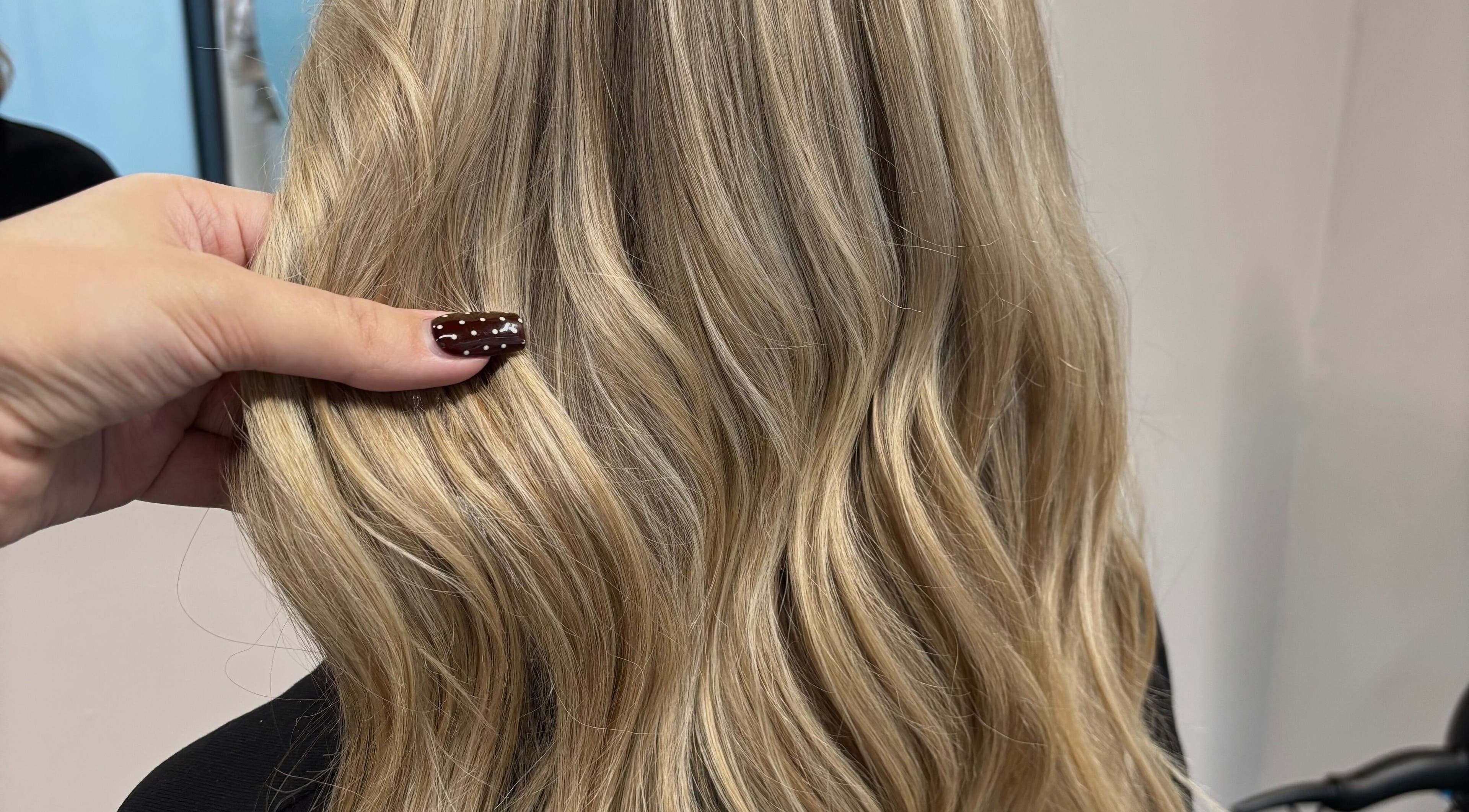 Blonde hair styled at Livedinbyerinx, Aberdeen, Scotland, GB, showcasing a wavy look.