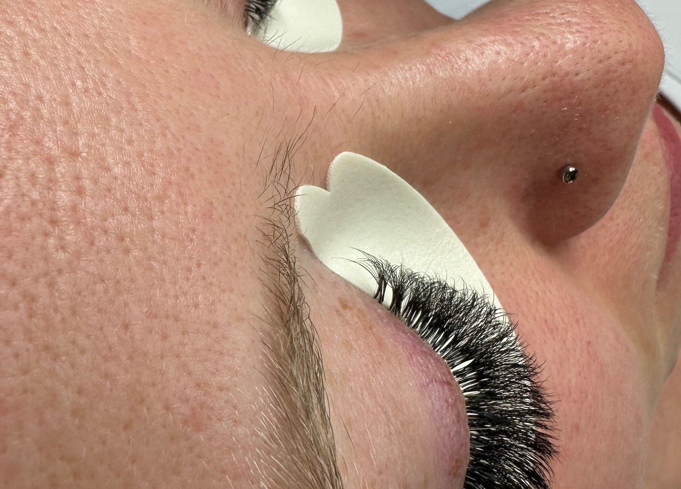 Client receiving eyelash extension treatment at Lashing Out by Amber in Courtenay, British Columbia, CA.