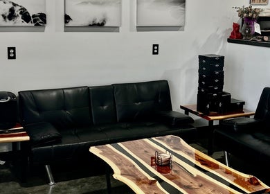 Welcoming lounge area at Piercings with Alina in Conroe, Texas, US featuring modern black seating.