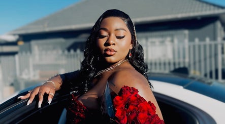 Elegant woman in red attire at Fleur Luxe Beauty, Cape Town, Western Cape, ZA, exuding confidence and style.