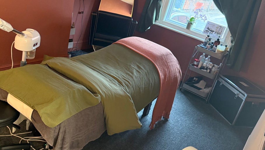 Relaxing massage setup at Kanji Japanese Head Spa & Wellness, Gloucester, England, GB, with warm, cozy ambiance.