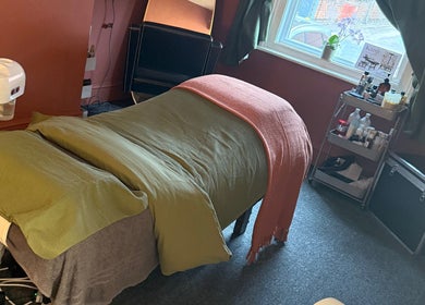 Relaxing massage setup at Kanji Japanese Head Spa & Wellness, Gloucester, England, GB, with warm, cozy ambiance.