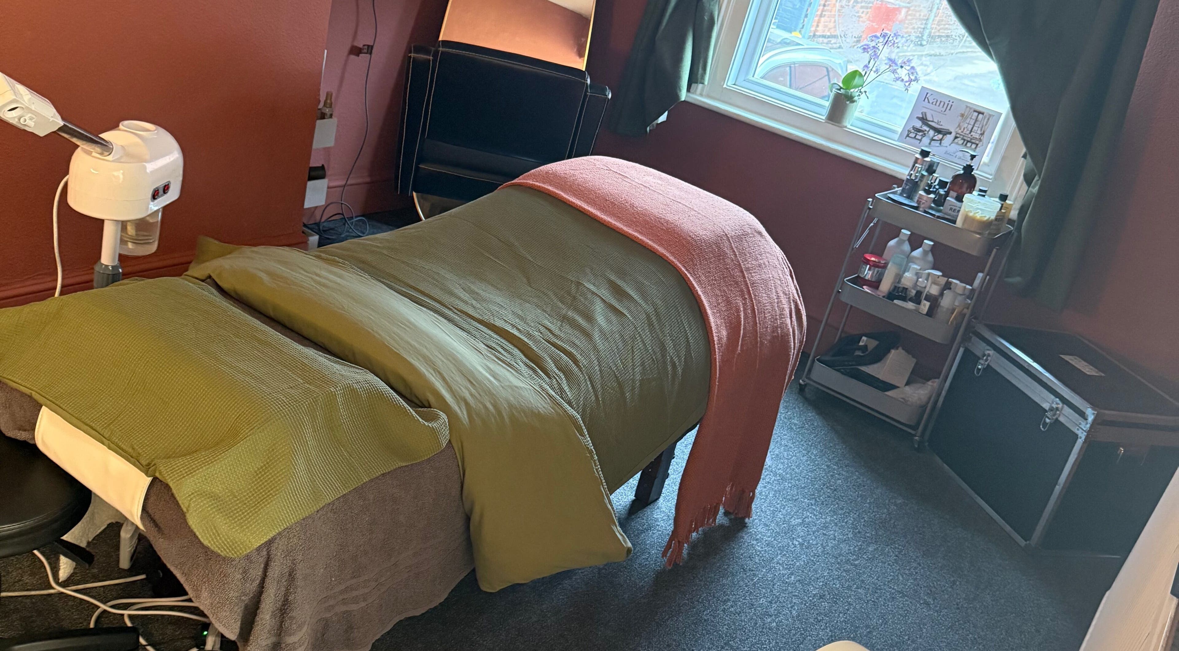 Relaxing massage setup at Kanji Japanese Head Spa & Wellness, Gloucester, England, GB, with warm, cozy ambiance.