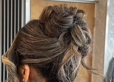 Elegant updo hairstyle created at Leila Keogh Hair, Royal Leamington Spa, England, GB, showcasing chic braiding.