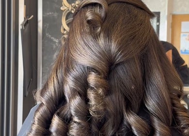 Elegant curly hairstyle at Leila Keogh Hair salon, Royal Leamington Spa, England, GB.