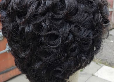 Close-up of intricate curls styled at Bozenga Beauty, Manchester, England, GB, showcasing hair artistry.