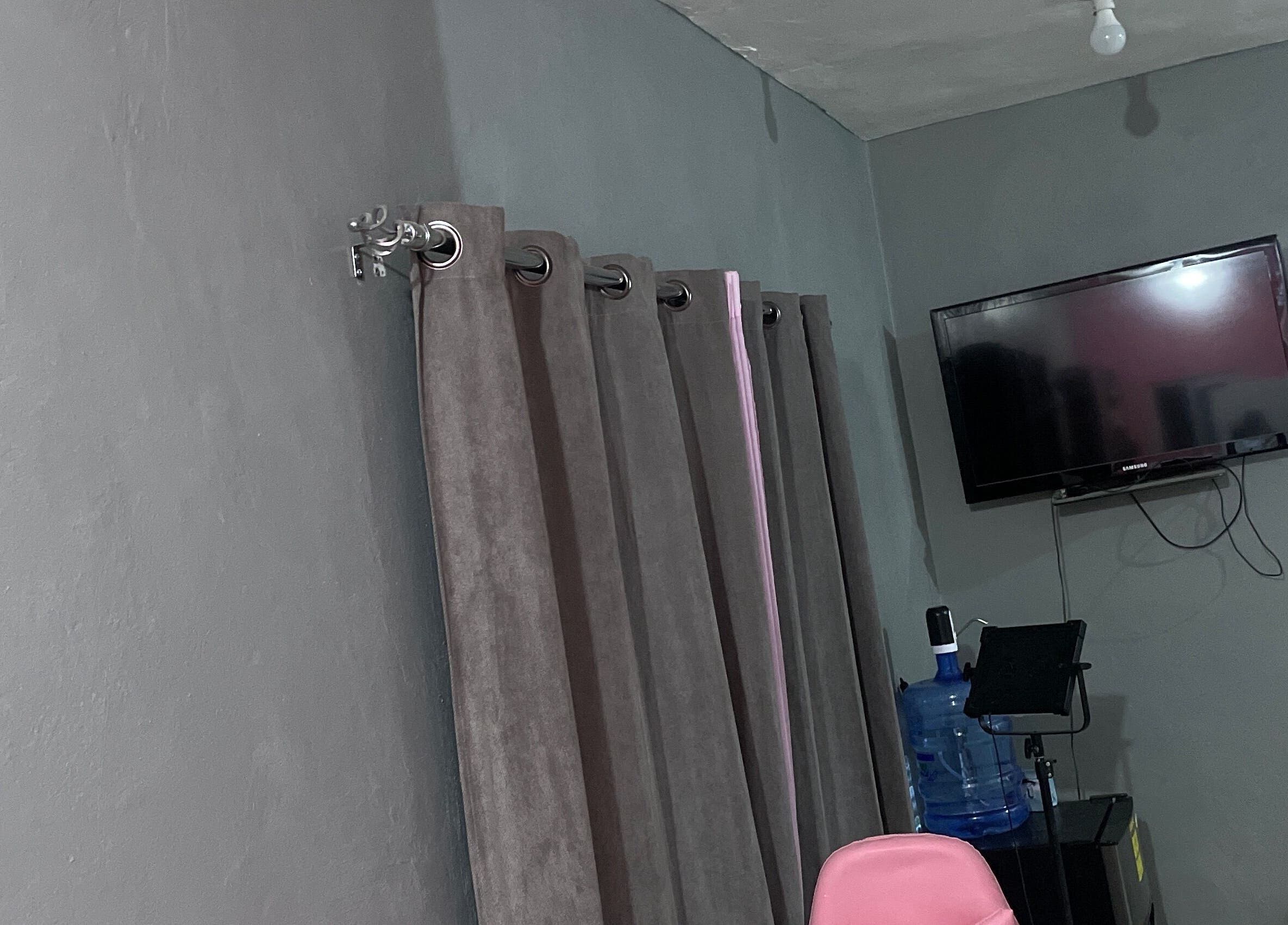 Stylish interior of Shanthenailslayer in Montego Bay, St. James Parish, JM with TV and decor accents.