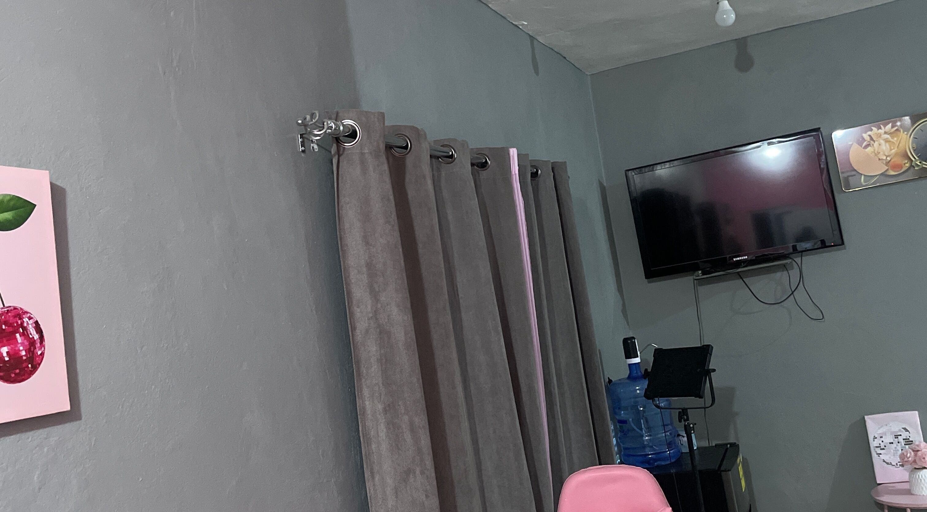 Stylish interior of Shanthenailslayer in Montego Bay, St. James Parish, JM with TV and decor accents.