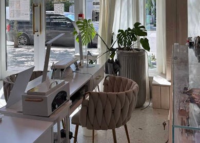 Elegant interior of MueseoYu Nail in Vancouver, British Columbia, CA with stylish seating and natural light.
