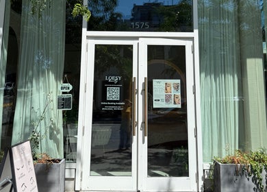Front entrance of MueseoYu Nail in Vancouver, British Columbia, CA with open sign and details displayed.