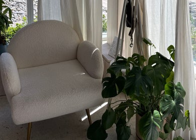 Comfortable chair with lush greenery at MueseoYu Nail, Vancouver, British Columbia, CA.