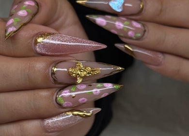 Intricate floral nail art at MG Velvet Pro, Brentwood, California, US showcasing gold details with rose designs.