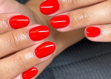 Vibrant red manicure at MG Velvet Pro, Brentwood, California, US, showcasing professional nail artistry.