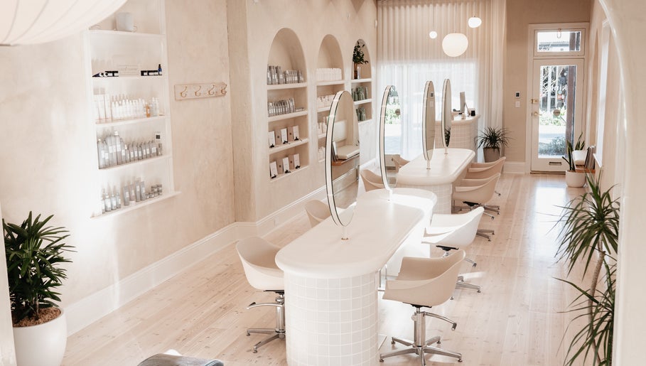 Elegant beauty salon interior at Kink, Victor Harbor, South Australia, AU with modern decor and styling stations.