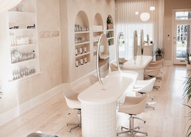Elegant beauty salon interior at Kink, Victor Harbor, South Australia, AU with modern decor and styling stations.