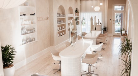 Elegant beauty salon interior at Kink, Victor Harbor, South Australia, AU with modern decor and styling stations.