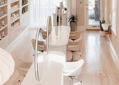 Elegant salon interior at Kink in Victor Harbor, South Australia, AU showcasing modern styling stations.