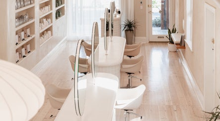 Elegant salon interior at Kink in Victor Harbor, South Australia, AU showcasing modern styling stations.