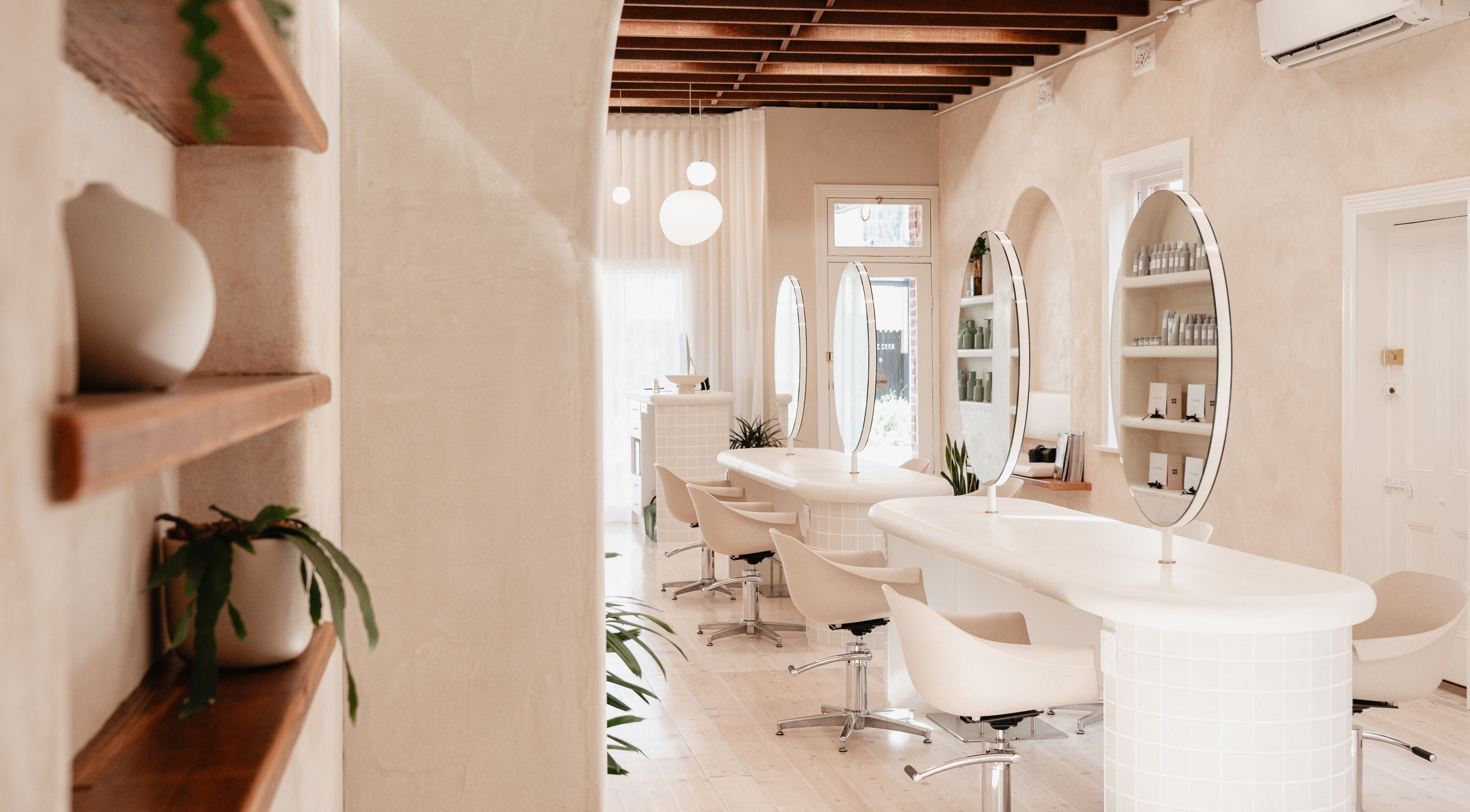 Modern beauty salon at Kink, Victor Harbor, South Australia, AU featuring elegant styling stations.