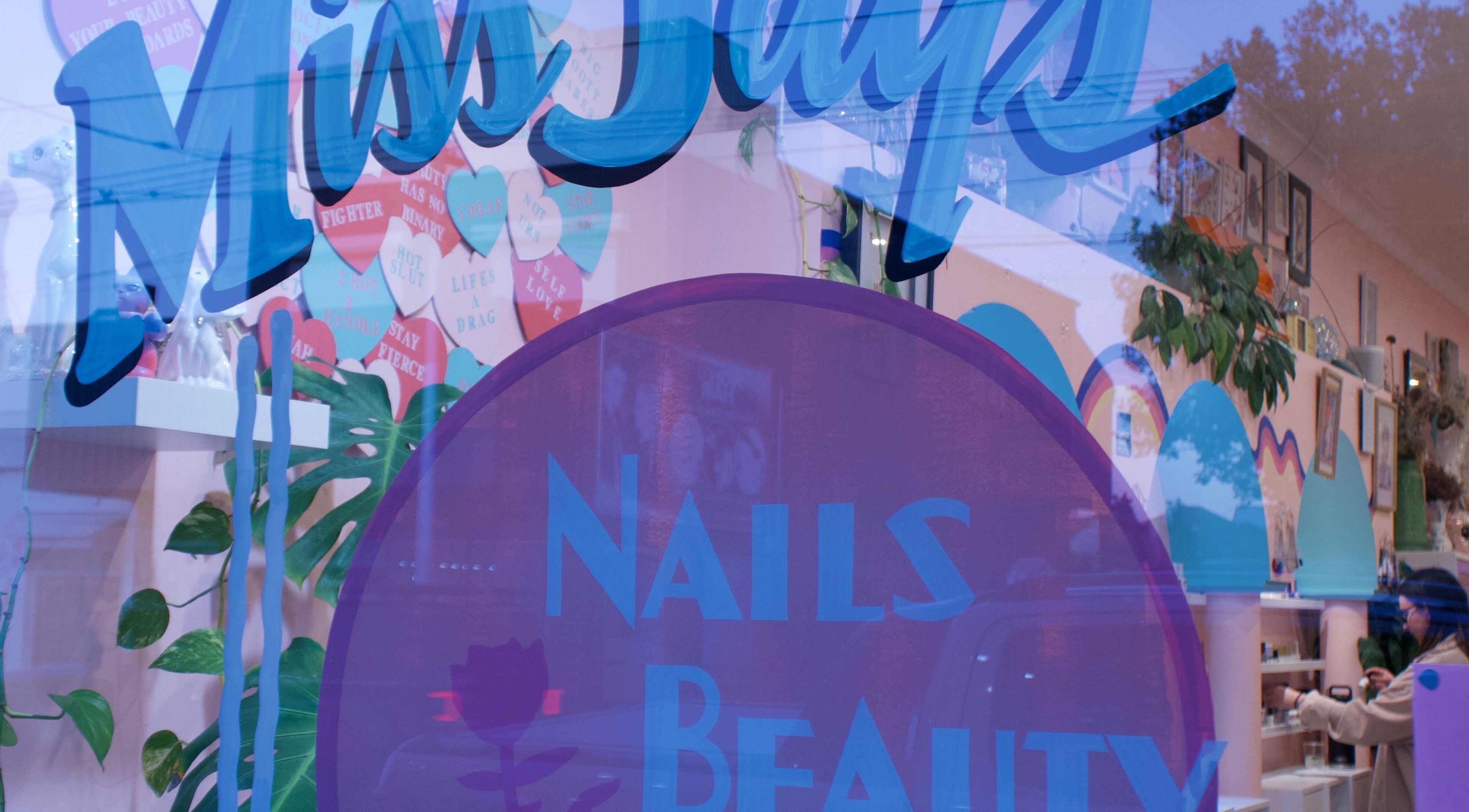Exterior shot of Junoxwatt, Melbourne, Victoria, AU, showcasing colorful nail and beauty signage.