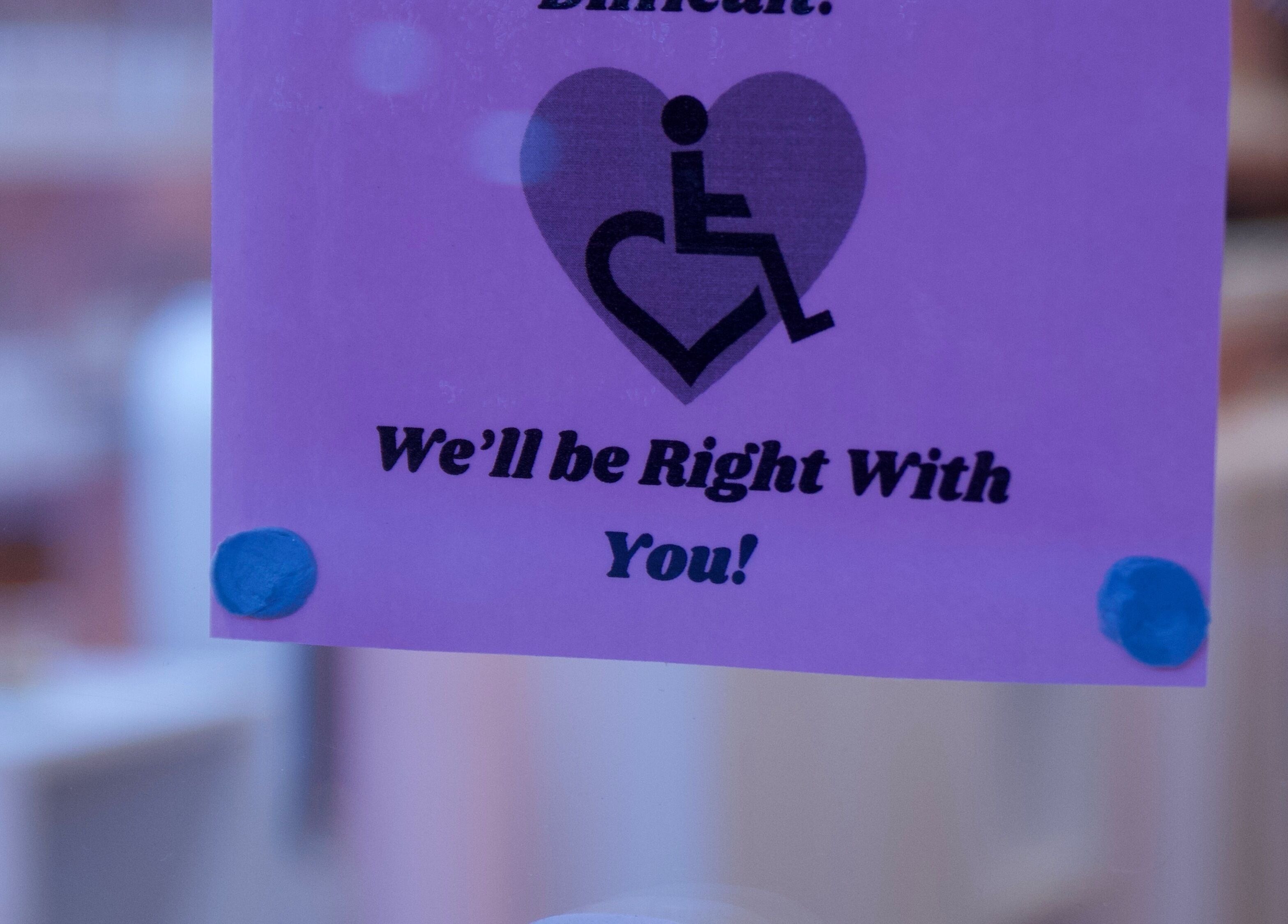 Accessibility sign at Junoxwatt, Melbourne, Victoria, AU, promising assistance.