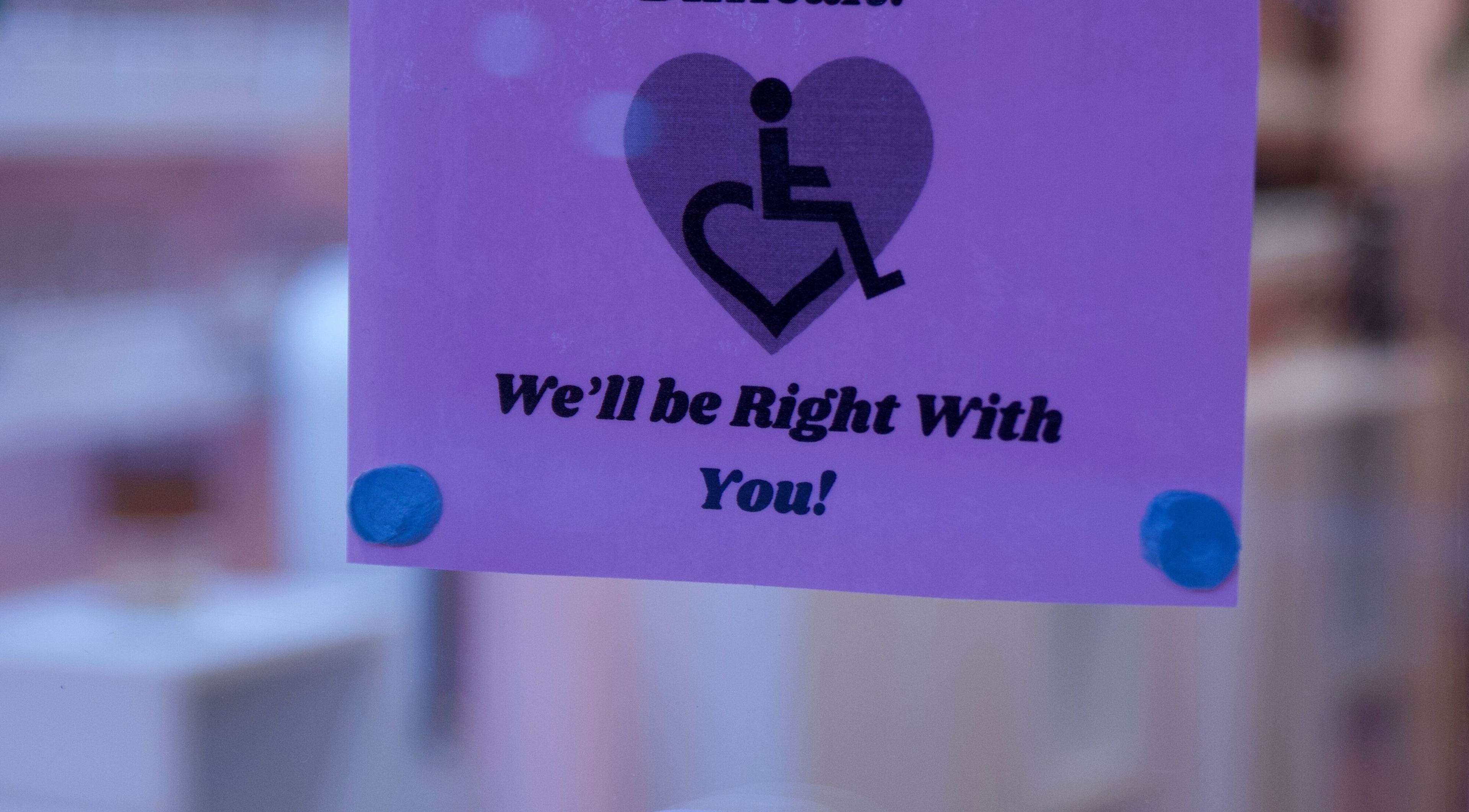 Accessibility sign at Junoxwatt, Melbourne, Victoria, AU, promising assistance.