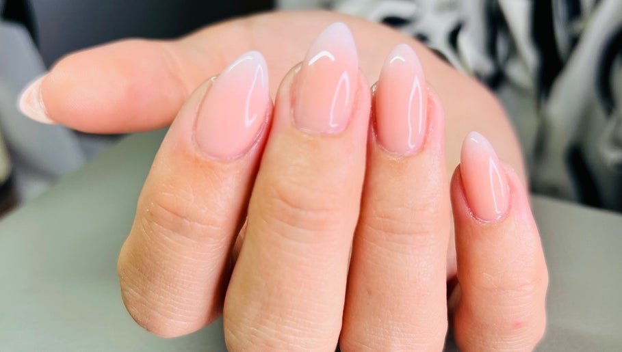 Elegant, glossy nails in soft pink at Cure, Appleby, NZ. Perfect manicure for all occasions.