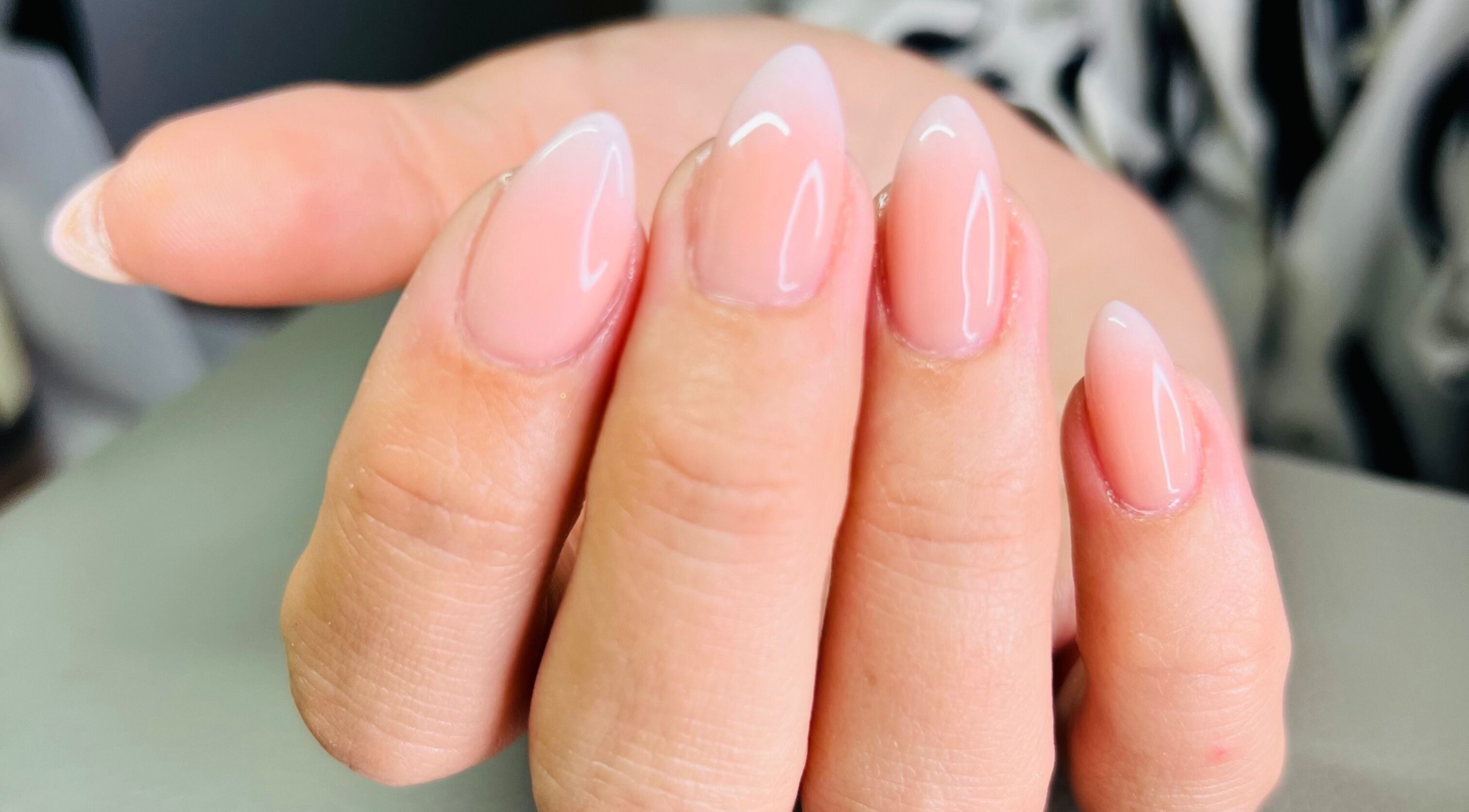 Elegant, glossy nails in soft pink at Cure, Appleby, NZ. Perfect manicure for all occasions.