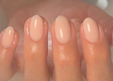 Close-up of freshly manicured nails at Cure in Appleby, NZ. Glossy, natural finish.