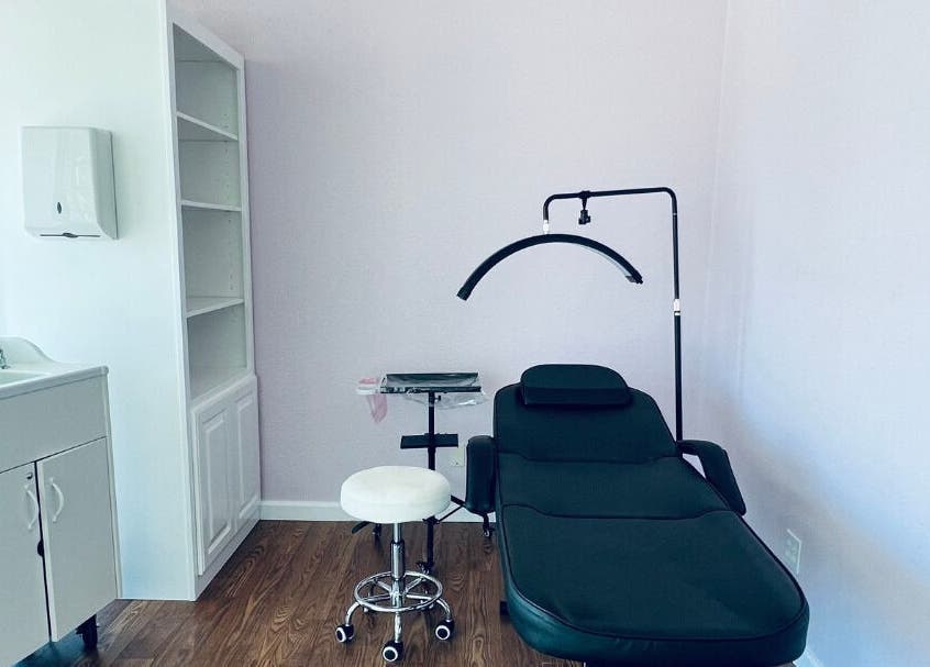 Cendelle treatment room in San Antonio, Texas, US, featuring a comfortable black chair and soothing ambiance.