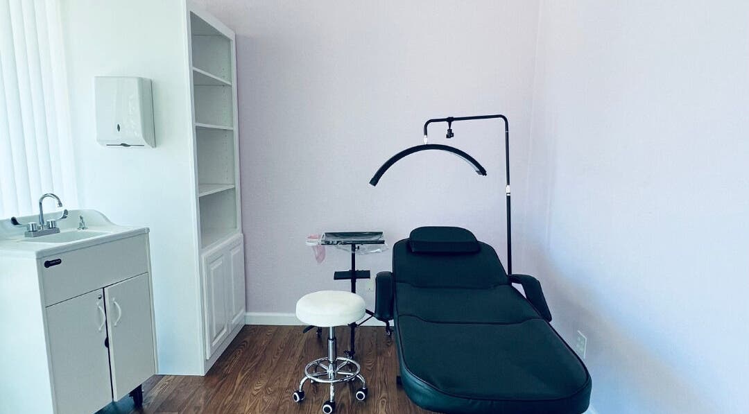 Cendelle treatment room in San Antonio, Texas, US, featuring a comfortable black chair and soothing ambiance.