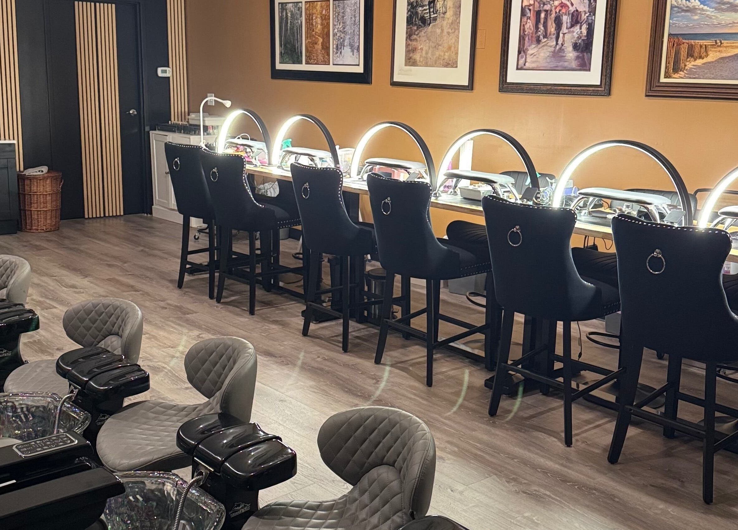 Chic nail salon setup at Lamour Nails in Orem, Utah, US, featuring stylish chairs and illuminated desks.