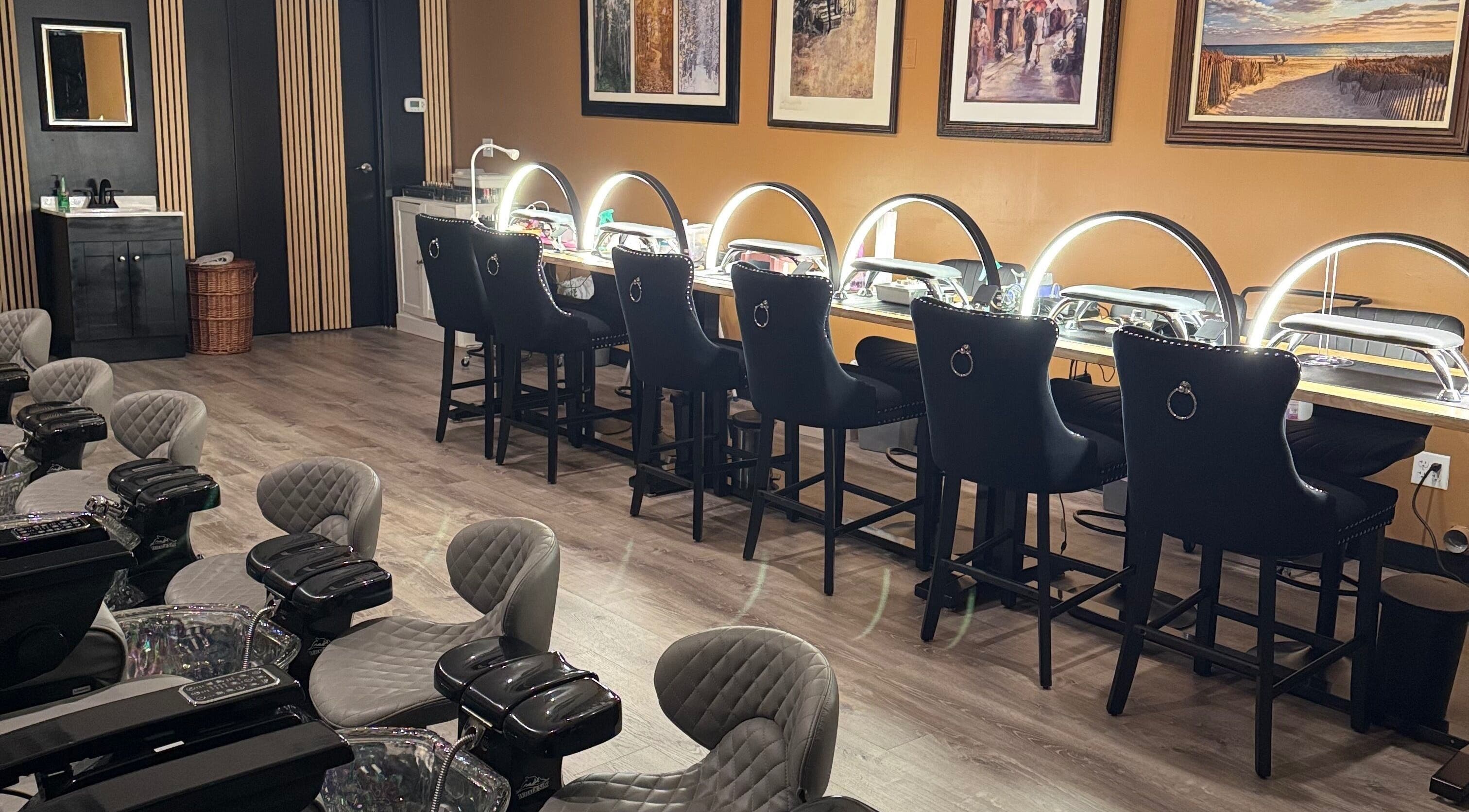 Chic nail salon setup at Lamour Nails in Orem, Utah, US, featuring stylish chairs and illuminated desks.