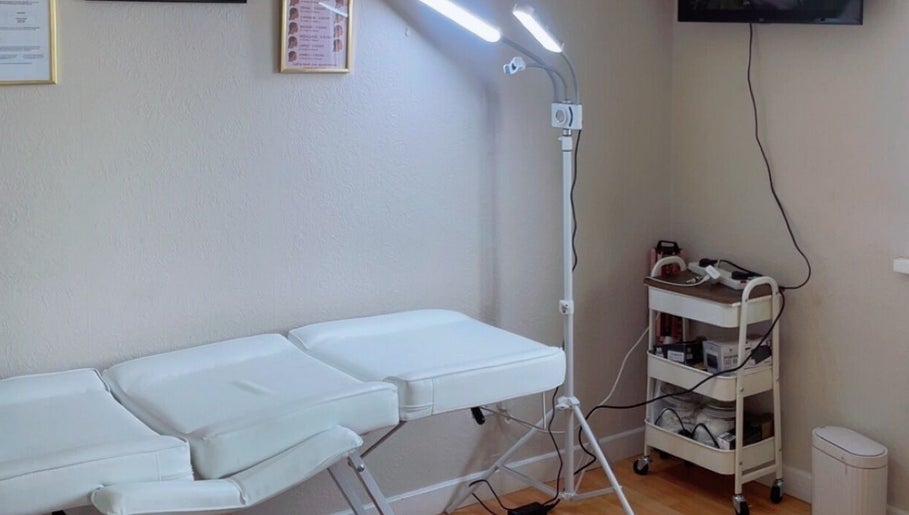 Spa treatment room at TY Beauty in Portadown, Northern Ireland, GB, featuring a comfortable massage bed and lighting.