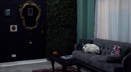 Chic lounge area at The Black Rabbit skin clinic, Newcastle, New South Wales, AU, featuring a cozy sofa.