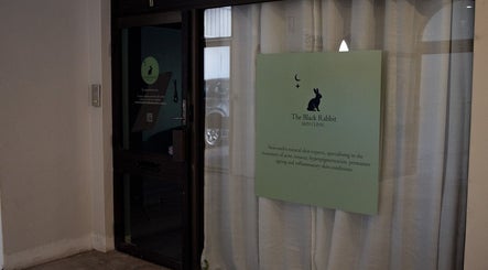 Entrance of The Black Rabbit skin clinic in Newcastle, New South Wales, AU with signage displaying services.