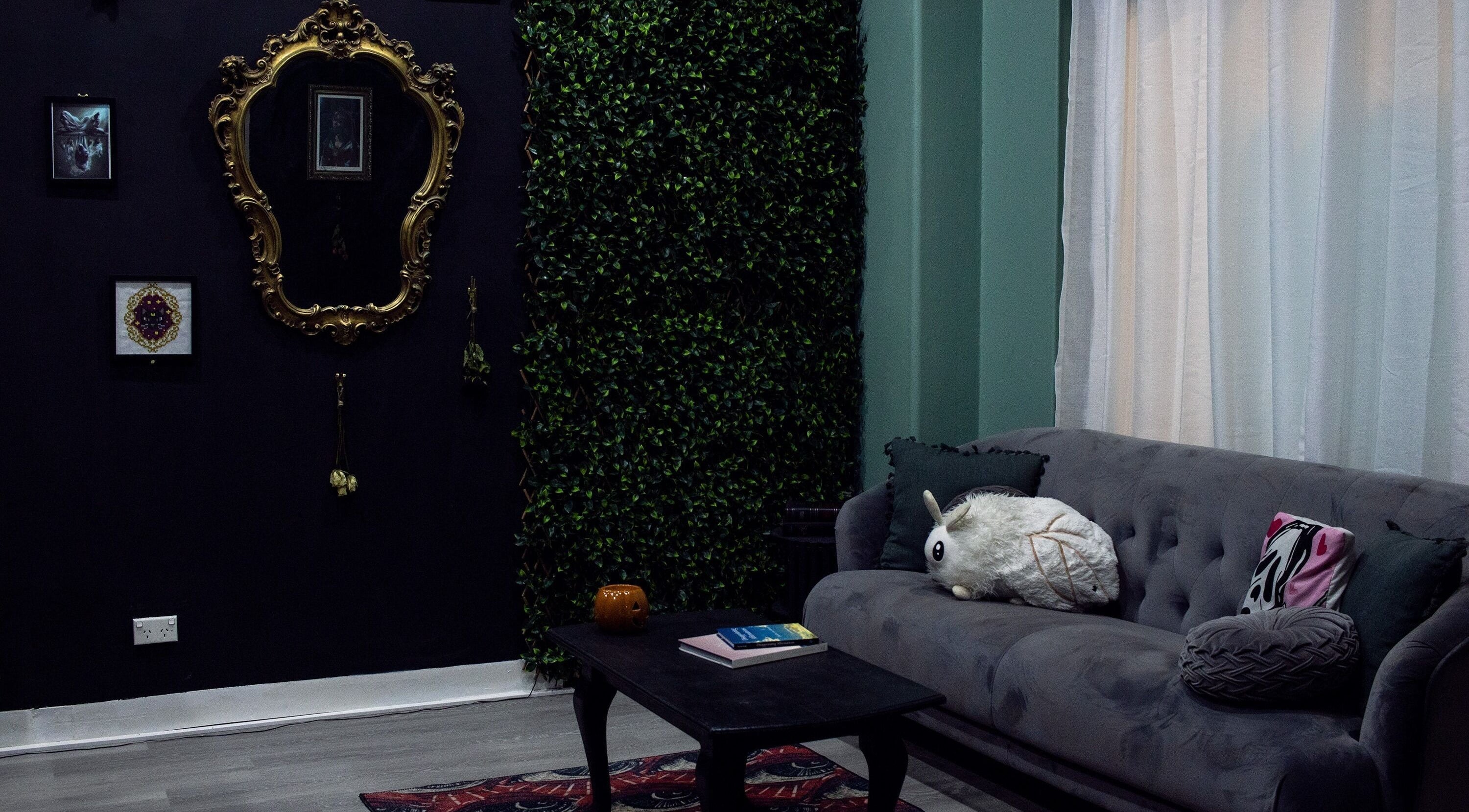 Elegant lounge at The Black Rabbit skin clinic, Newcastle, New South Wales, AU with vintage decor and plush sofa.